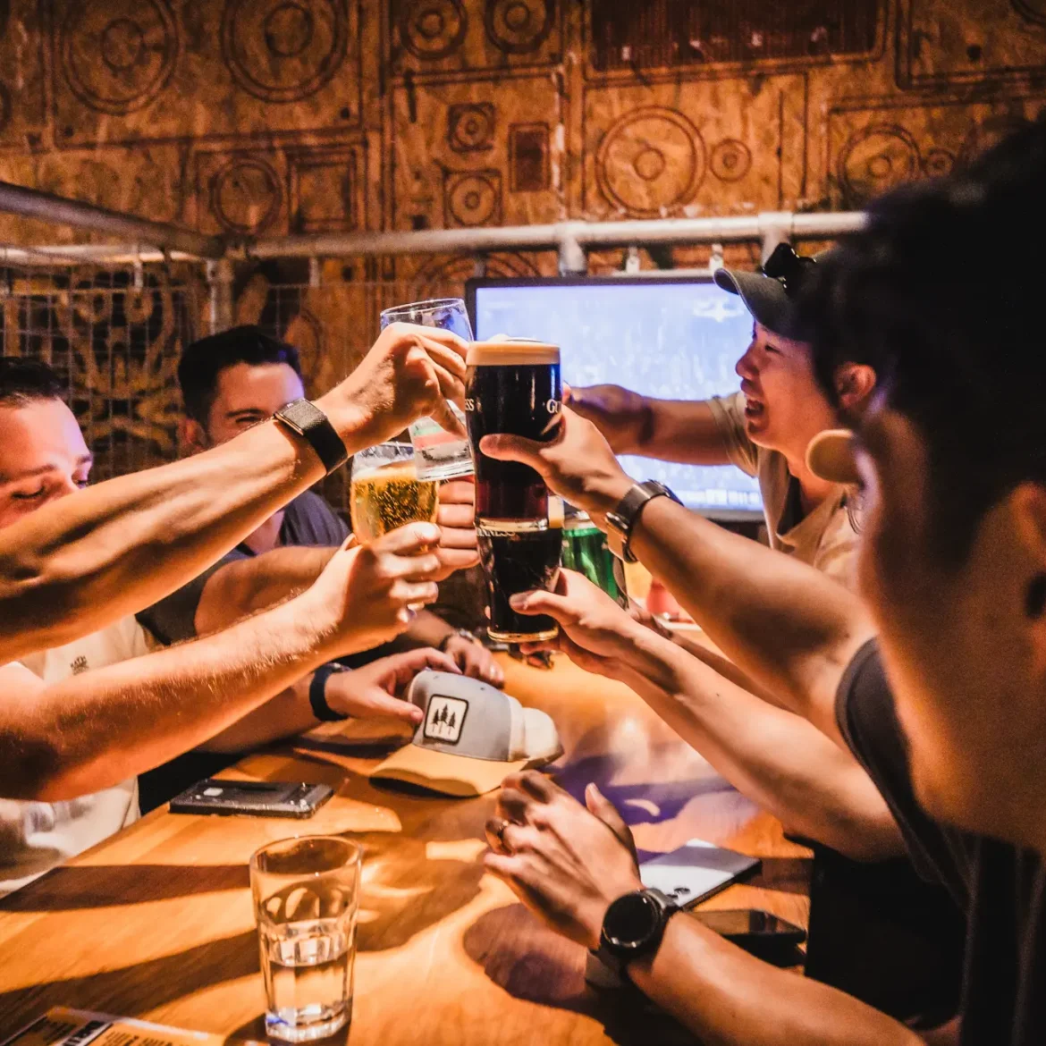 International football fans toasting with craft beers and Guinness at Belushi's sports bar while watching the World Cup live, the atmosphere that makes match day worth it