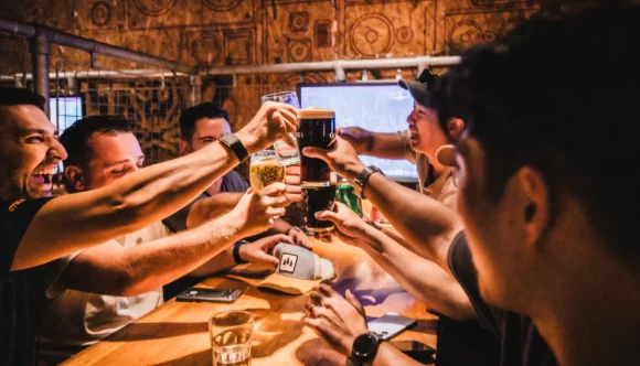 International football fans toasting with craft beers and Guinness at Belushi's sports bar while watching the World Cup live, the atmosphere that makes match day worth it