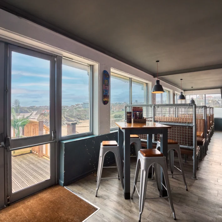 Belushi's Newquay clifftop sports bar in Cornwall showing projector and screens for watching the World Cup live above Newquay bay