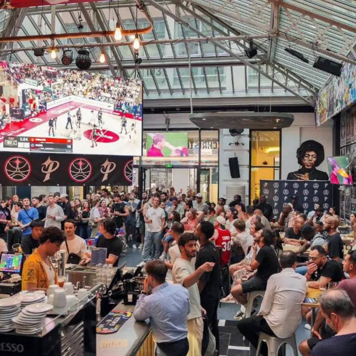 Belushi's Paris Gare du Nord large capacity sports bar packed with international football fans watching the World Cup live on massive digital screens near Gare du Nord station