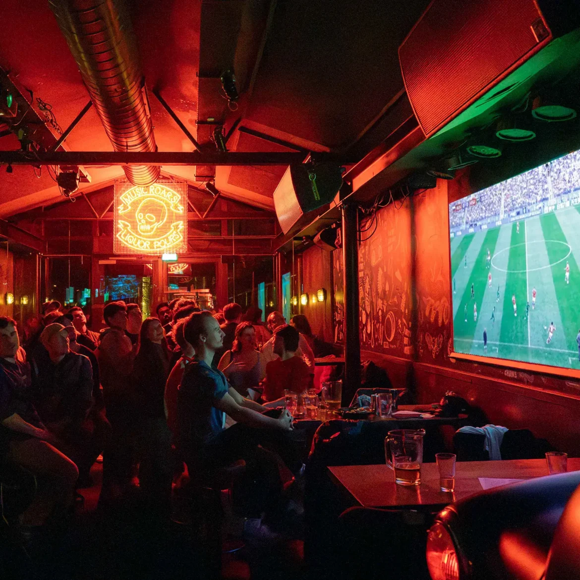 Packed crowd of football fans watching the world cup at Belushi's Amsterdam on the projector screen.