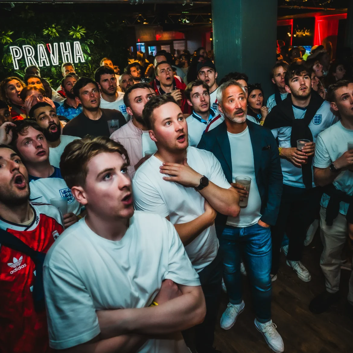 Packed crowd of passionate football fans generating an electric atmosphere watching the World Cup live at Belushi's sports bar