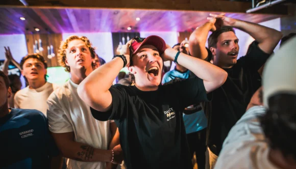 Football fan reacting to a big moment watching live football on a big screen at Belushi's sports bar, the electric atmosphere only a live match can create