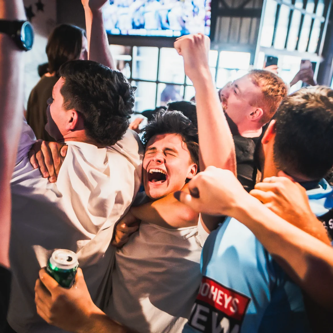 Pure World Cup goal celebration at Belushi's sports bar, the kind of electric crowd atmosphere that makes watching live football together completely unforgettable